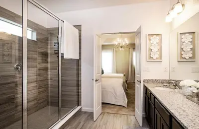 a bathroom with a walk in shower and a sink at Flash 20 Off Gorgeous Vacation Home near Everywhere in Kissimmee