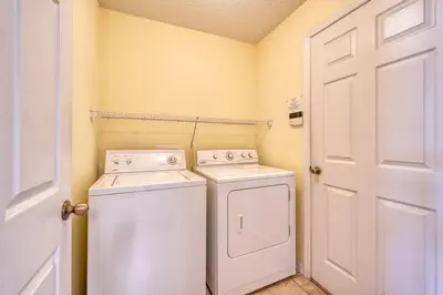 a laundry room with a washer and dryer at Flash 20 Off Private Pool Home at Lake Berkley Resort in Kissimmee