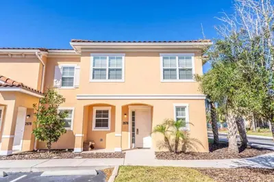 a large house with trees in front of it at Flash 20 Off Private Spa Townhome at Regal Oaks Resort in Orlando