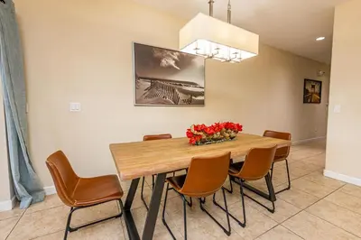 a dining room with a wooden table and chairs at Flash 20 Off Spetacular TownHome With Private Pool close to Disney 8919PP in Kissimmee
