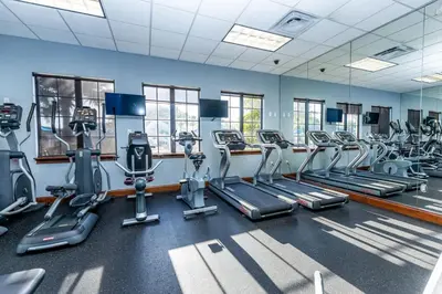 a gym with treadmills and elliptical machines at Flash 20 Off Spetacular TownHome With Private Pool close to Disney 8919PP in Kissimmee