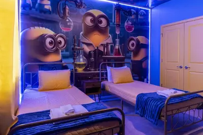 two beds in a room with a wall with eyes at Sophisticated 9 bedroom close to Disney in Kissimmee
