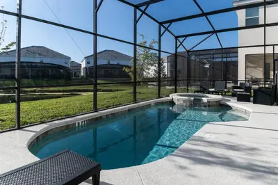 a swimming pool in front of a building at Sophisticated 9 bedroom close to Disney in Kissimmee