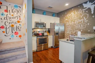 a kitchen with white cabinets and a refrigerator at Special Offer Cozy Townhome at West Lucaya in Kissimmee