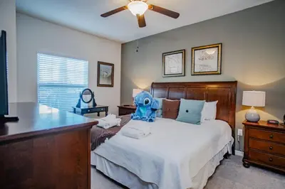 a bedroom with a large bed and a ceiling fan at Special Offer Cozy Townhome at West Lucaya in Kissimmee