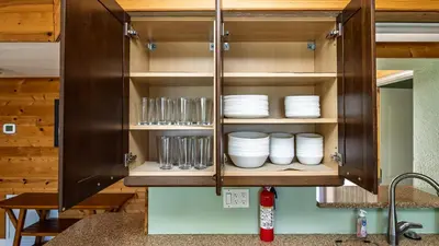 a kitchen cabinet with plates and glasses in it at Lakefront Retreat - Boat - Fish - Close to all Orlando Parks - Disney - Universal - SeaWorld in Orlando