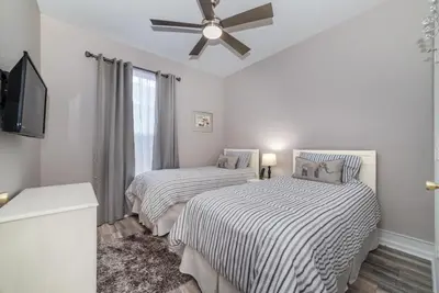 a bedroom with two beds and a ceiling fan at Special Offer Beautiful Pvt Pool home in Kissimmee