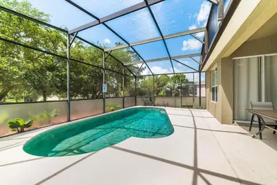an indoor swimming pool in a house with a glass ceiling at Special Offer Beautiful Pvt Pool home in Kissimmee