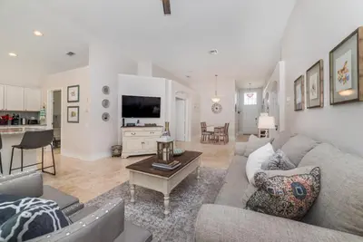a living room with a couch and a table at Special Offer Beautiful Pvt Pool home in Kissimmee