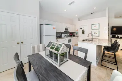 a kitchen and dining room with a table and chairs at Special Offer Beautiful Pvt Pool home in Kissimmee