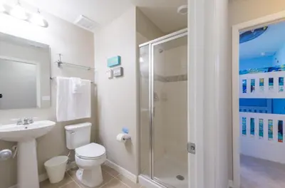 a bathroom with a toilet sink and a shower at Special Offer Cozy Retreat at Compass Bay in Kissimmee