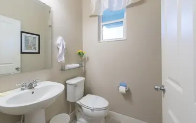a white bathroom with a sink and a toilet at Special Offer Cozy Retreat at Compass Bay in Kissimmee