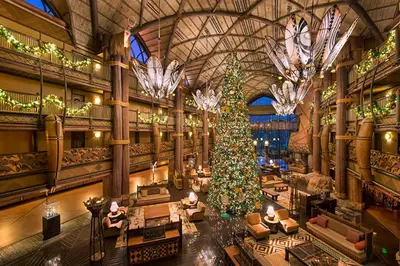 a christmas tree in a hotel lobby with a christmas tree at Disney's Animal Kingdom Villas - Kidani Village in Orlando