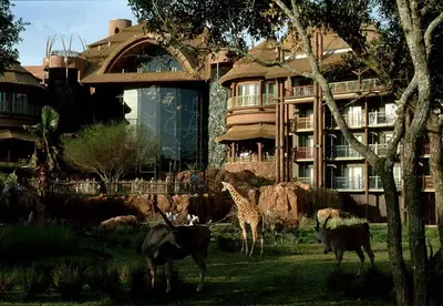 a giraffe and other animals in front of a building at Disney's Animal Kingdom Villas - Kidani Village in Orlando