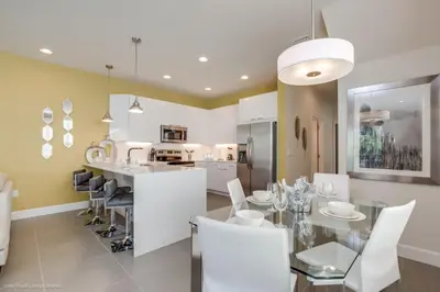 a kitchen and dining room with a table and chairs at Special Offer Luxury Retreat with Pool in Orlando
