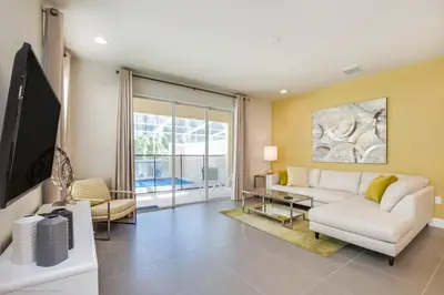 a living room with a white couch and a tv at Special Offer Luxury Retreat with Pool in Orlando