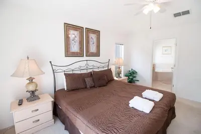 a bedroom with a large bed with two towels on it at Special Offer Private Pool Home at Seasons Community in Kissimmee