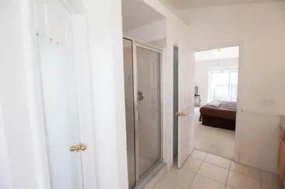 a bathroom with a walk in shower next to a bedroom at Special Offer Private Pool Home at Seasons Community in Kissimmee