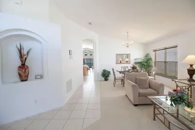 a living room with a couch and a table at Special Offer Private Pool Home at Seasons Community in Kissimmee