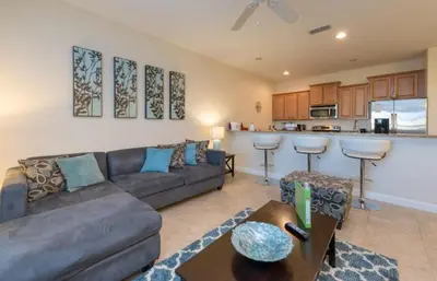 a living room with a couch and a kitchen at Special Offer Pvt Pool Townhome in Kissimmee
