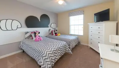 a bedroom with two twin beds and a tv at Special Offer Pvt Pool Townhome in Kissimmee