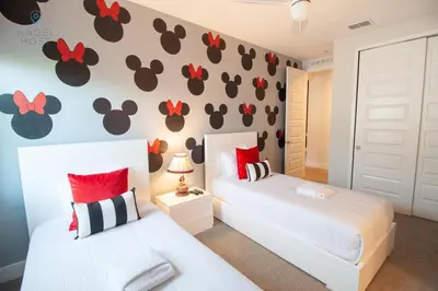 a bedroom with two beds and a wall with paw paw decals at Special Offer Pvt Pool and Spa Home at Encore in Orlando