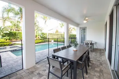 a dining room with a table and chairs and a pool at Special Offer Pvt Pool and Spa Home at Encore in Orlando