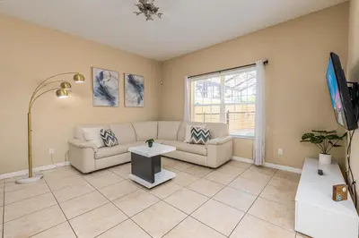 a living room with a couch and a tv at Special Offer Stunning TownHome With Private Pool close to Disney 8960PP in Kissimmee