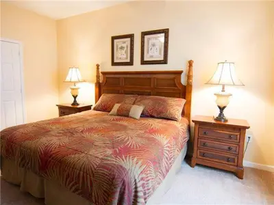 a bedroom with a bed and two night stands with lamps at Special Offer Stylish Apartment at Vista Cay Resort in Orlando