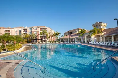 a swimming pool at a resort with chairs and condos at Special Offer Stylish Apartment at Vista Cay Resort in Orlando