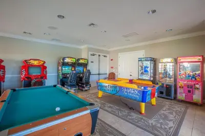 a room with a pool table and arcade games at Special Offer Stylish Apartment at Vista Cay Resort in Orlando