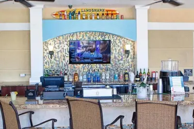 a bar in a restaurant with a tv on a wall at Special Offer Stylish Apartment at Vista Cay in Orlando