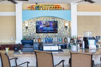 a bar in a restaurant with a tv on a wall at Stylish Apartment at Vista Cay in Orlando