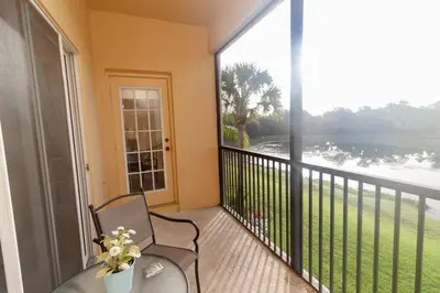 a balcony with a chair and a large window at Special Offer Townhome at Oakwater Resort in Orlando