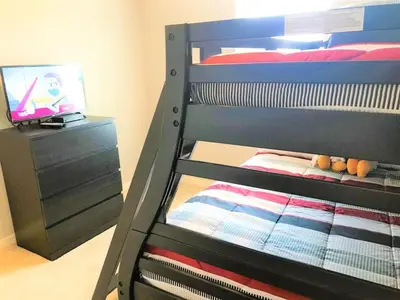 a bunk bed with a tv in a bedroom at TVPM5150CHCB in Kissimmee