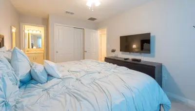 a bedroom with a large bed with a flat screen tv at TVPM5164ADCB in Kissimmee