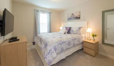 a bedroom with a bed and a flat screen tv at TVPM5164ADCB in Kissimmee