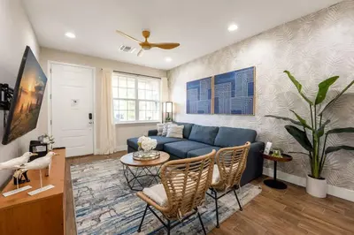 a living room with a blue couch and a table at New Listing - Modern decoration 4 BR Townhouse in Kissimmee
