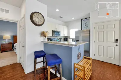 a kitchen with a counter and a clock on the wall at Charming Oasis with King Bed Close to Disney 4BR in Kissimmee