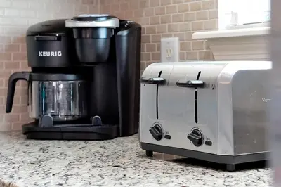 a coffee maker sitting on a counter next to a coffee machine at Charming Oasis with King Bed Close to Disney 4BR in Kissimmee