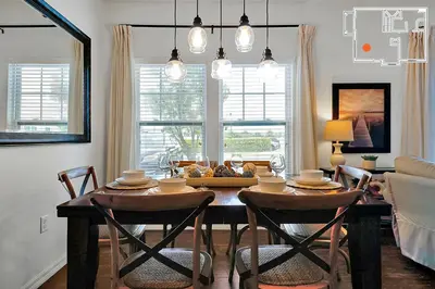 a dining room with a table and chairs and a couch at Charming Oasis with King Bed Close to Disney 4BR in Kissimmee
