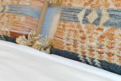 a close up of two pillows on a bed at Charming Oasis with King Bed Close to Disney 4BR in Kissimmee