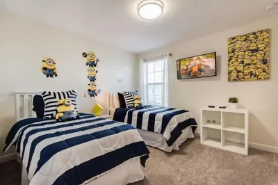 a bedroom with two beds with blue and white stripes at Casa Luxuosa 5Q c/ Piscina Perto da Disney! in Kissimmee