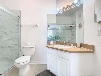 a bathroom with a toilet and a sink and a shower at Windsor Hills Amazing 3BR Condo,Pool,Slides,Disney in Orlando