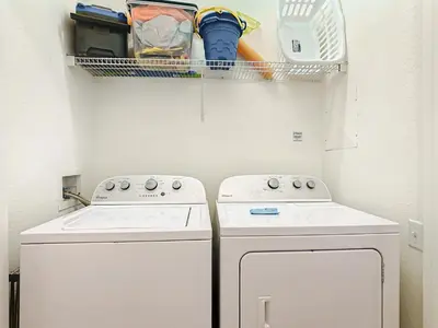 a kitchen with two white washers and a drying rack at Windsor Hills Amazing 3BR Condo,Pool,Slides,Disney in Orlando