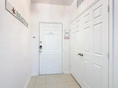 a white hallway with a white door and a tile floor at Windsor Hills Amazing 3BR Condo,Pool,Slides,Disney in Orlando