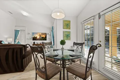 a dining room with a table and chairs at 373 - Stunning 4 Bedroom Villa with own Private South East Facing Pool in Orlando