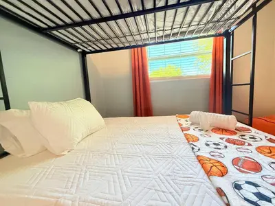 a bed in a room with a window at Spacious Orlando Stay Free Wifi Game Room in Orlando