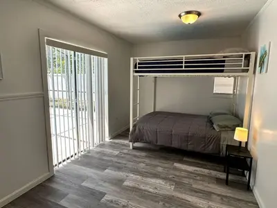 a bedroom with a bunk bed and a large window at Welcome to Altamonte Springs! in Orlando