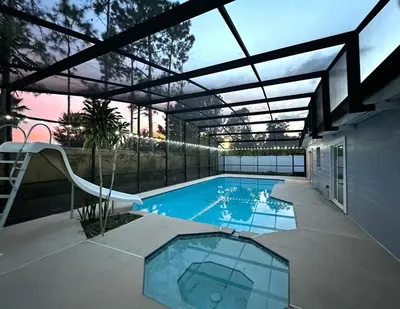 a large swimming pool with a glass roof at Welcome to Altamonte Springs! in Orlando